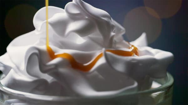Closeup of the cream of a milkshake.